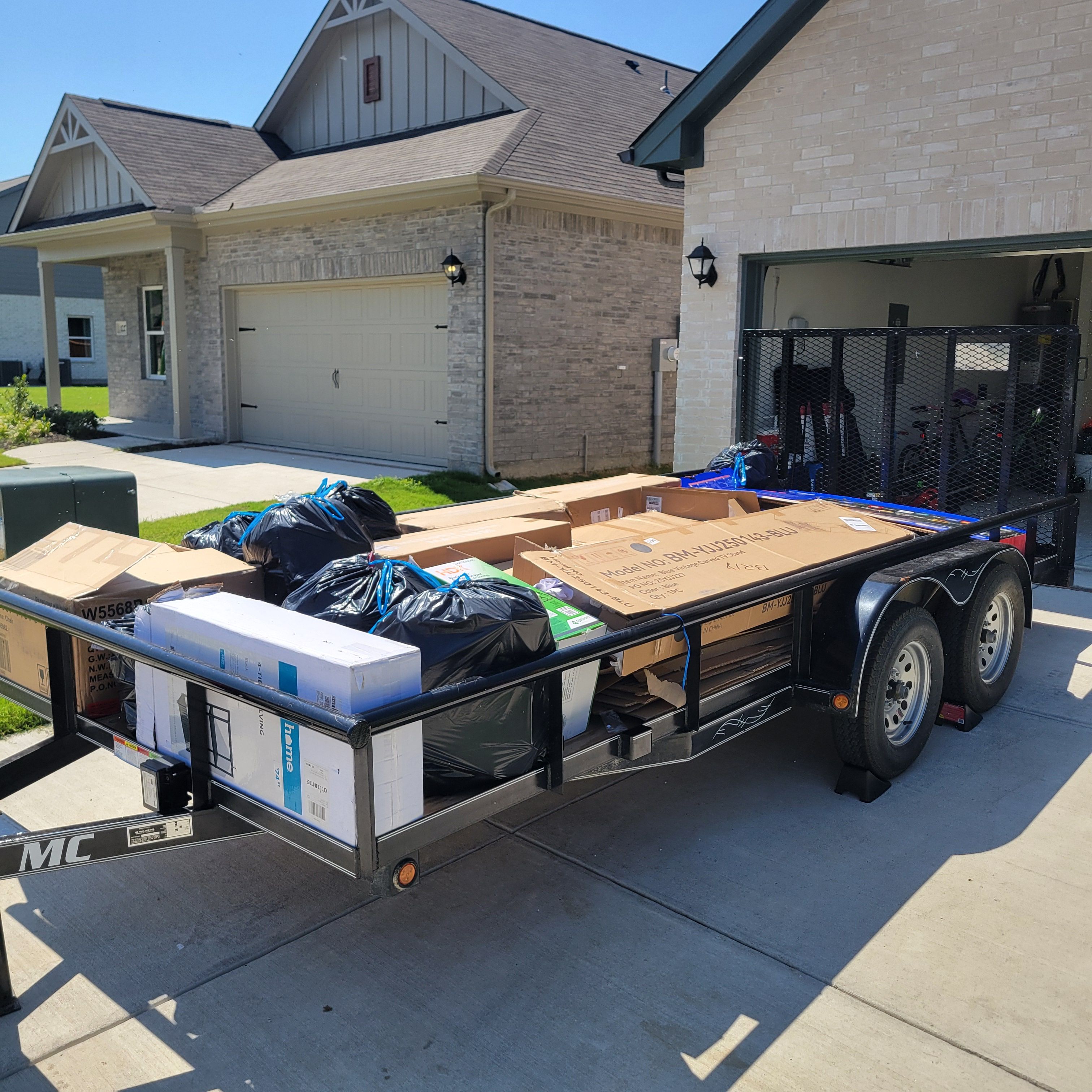 Iron Yoke LLC utility trailer loaded with boxes and household items for a local delivery in McKinney, TX