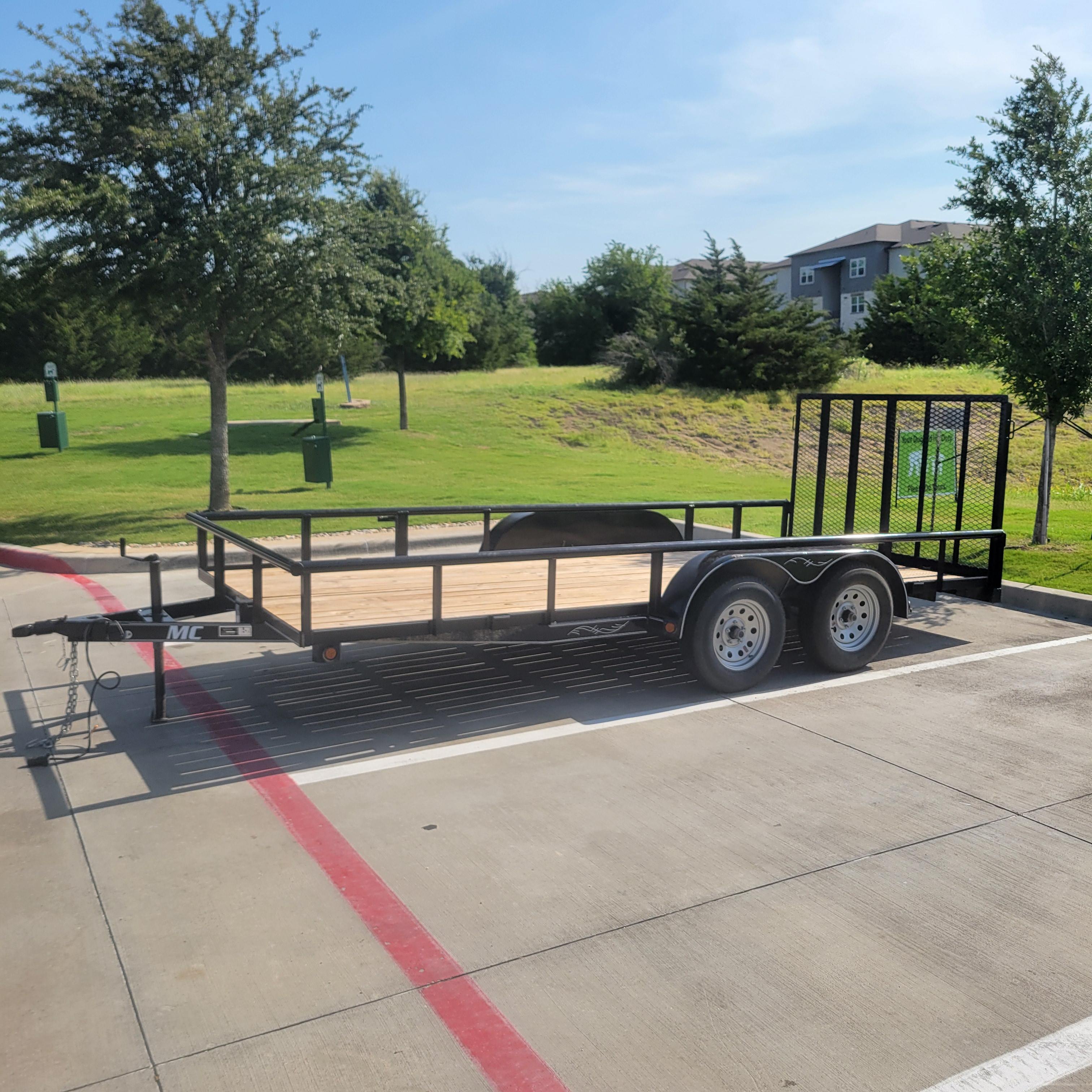 Iron Yoke LLC utility trailer side view showing full length dual axle and wooden deck for hauling